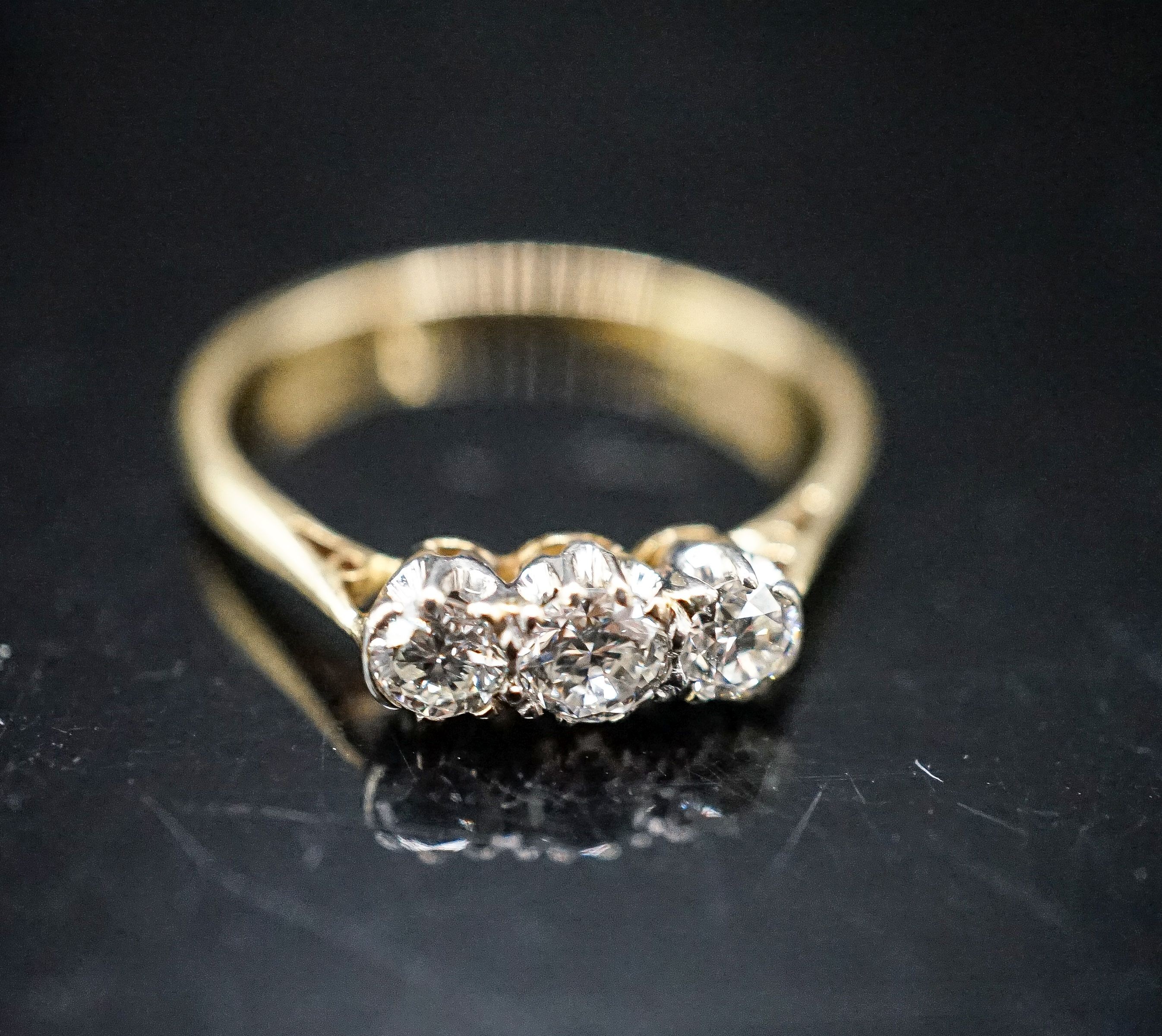 An 18ct & plat, three stone diamond ring, size O, gross 2 grams.